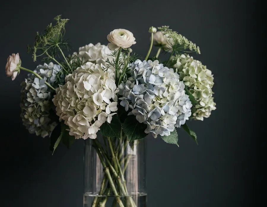 Top-down view of a diverse floral arrangement featuring vibrant orchids, carnations, and alstroemeria, known for their exceptional vase life, curated by Boston Flowers.