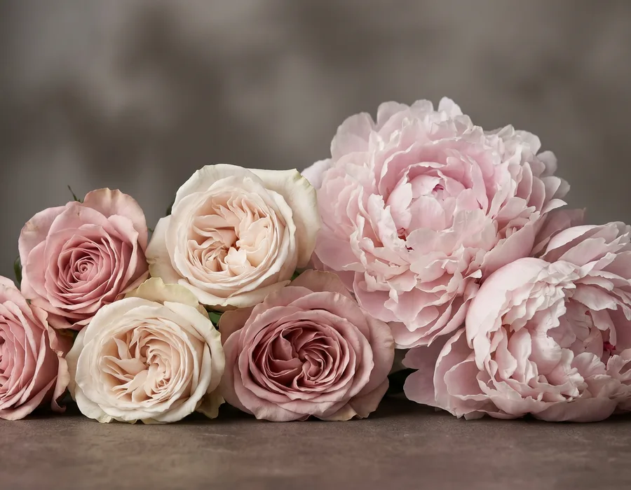 Comparison of lush roses and peonies in a wedding bouquet