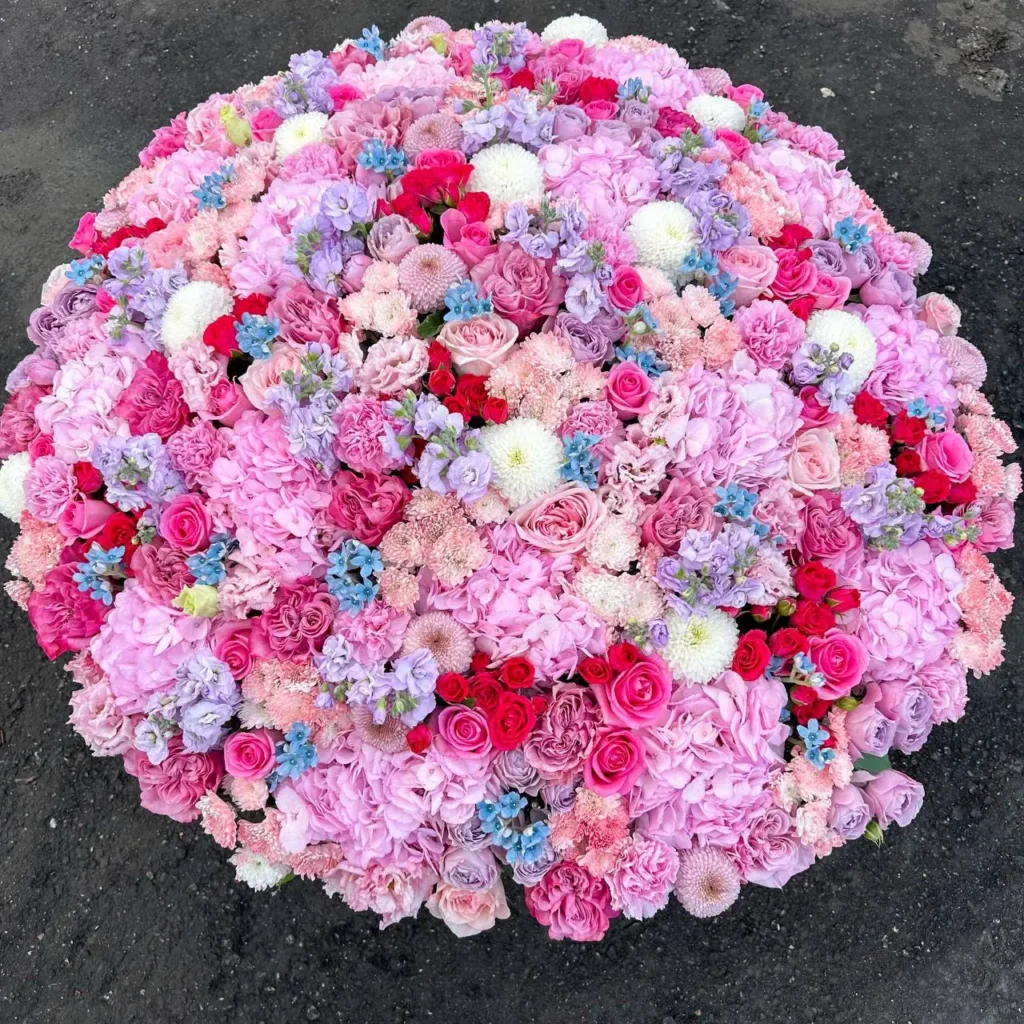 Luxury grand pink and red mixed floral basket arrangement by Boston Flowers for delivery in Boston