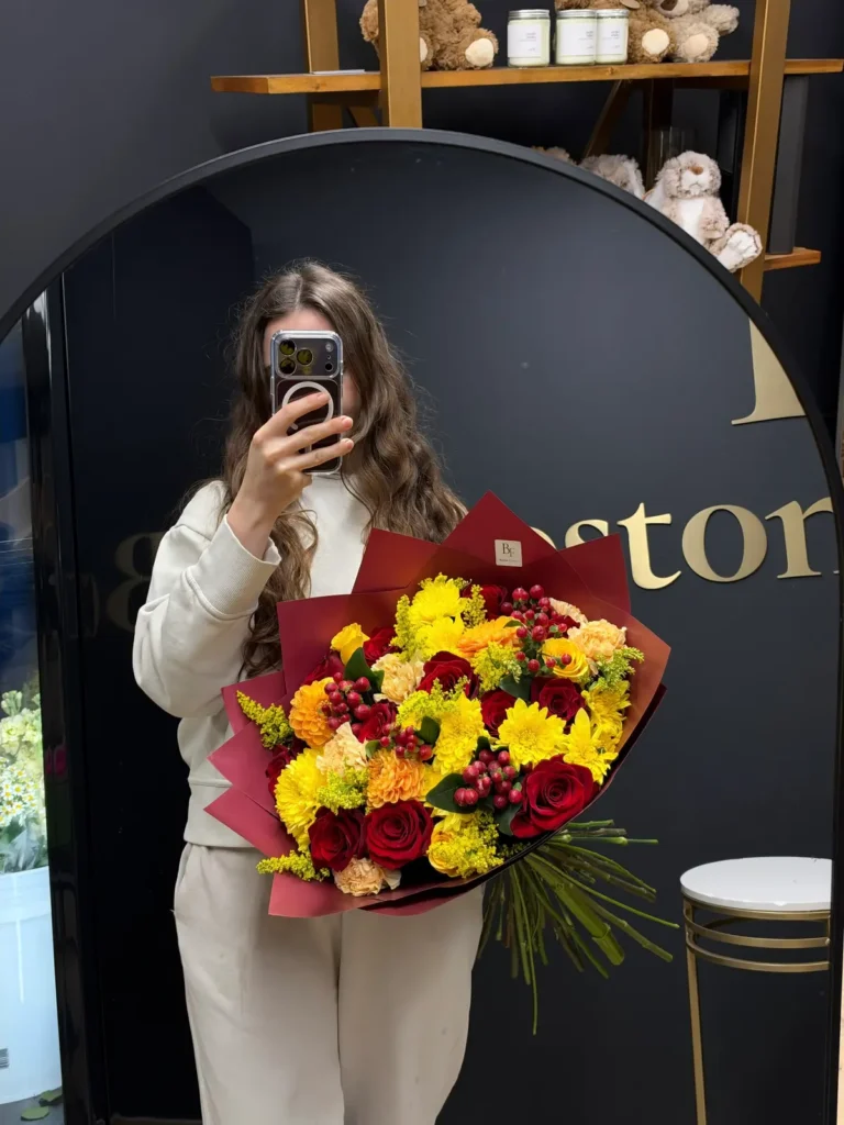 Boston Autumn Ember fall bouquet of red roses, yellow chrysanthemums, orange dahlias and red hypericum berries in burgundy wrap, view 2