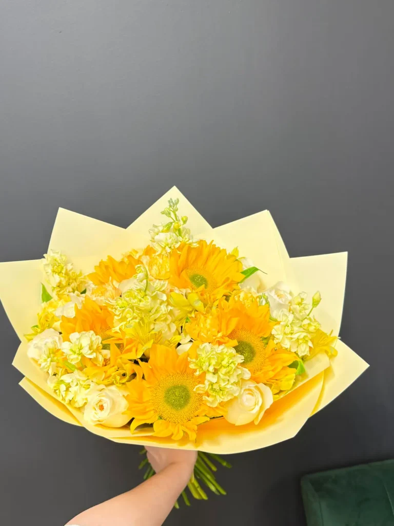 Fenway Sunbeam bouquet of sunflowers, cream roses, white stock and pale yellow accents in butter yellow wrap, view 2